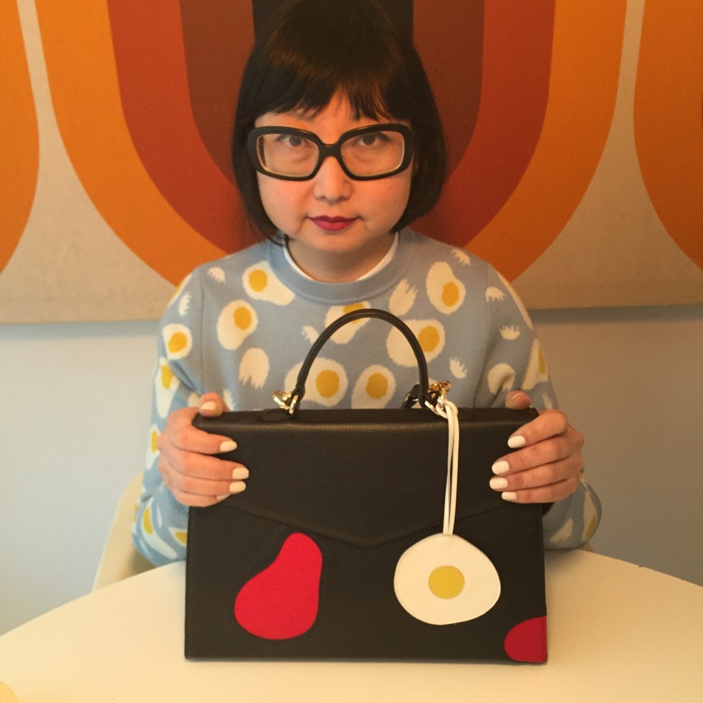 I love the charms that you can get to put on your bag.  I like to match my outfit with the charm, like this egg charm which matches my Lazzari sweater designed by Olimpia Zagnoli whose graphic design work I really admire.