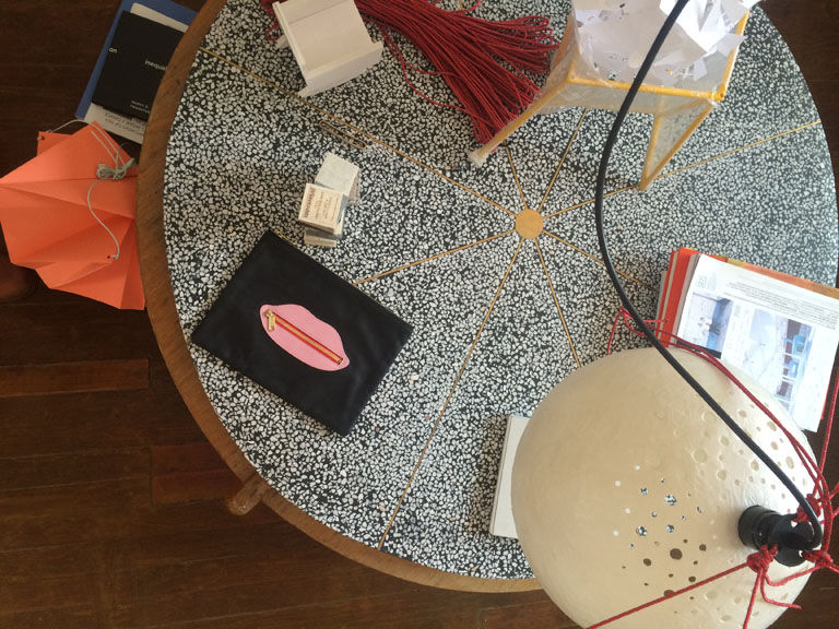At my studio, Pedro&Juana, the Lips are on a prototype of a table top made of terrazzo with brass. To the right is a lampshade made of paper and all around are experiments for objects, buildings, textures …